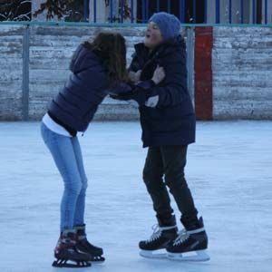 Happy children skating on Delbono mountain rent skating rink