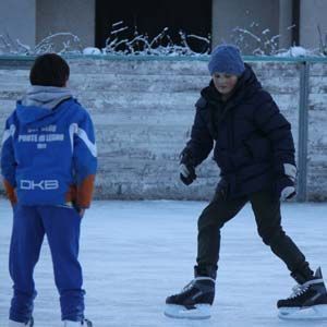 Happy children skating on Delbono mountain rent skating rink